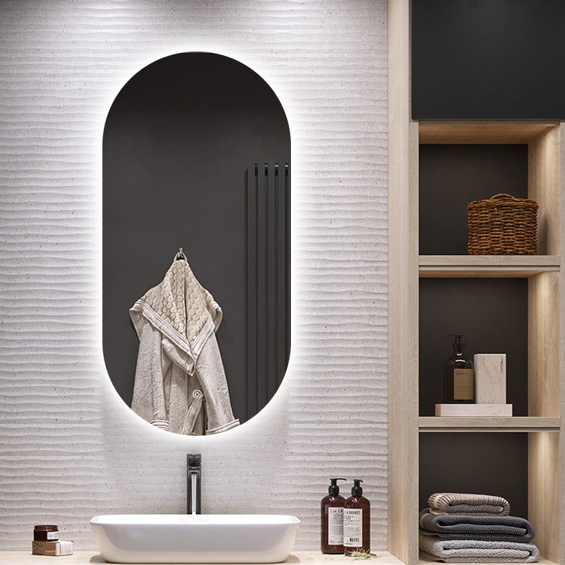 Bathroom interior with a black oval mirror, sink, and shelves with towels and bottles.
